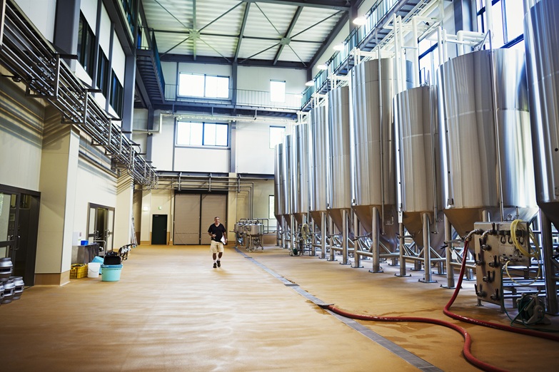 Interior view of a brewery with a row of metal beer tanks.,Bairds Brewery,Japan